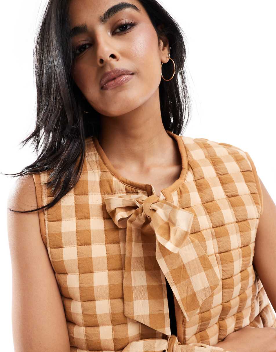 ASOS DESIGN quilted vest with bows in brown gingham