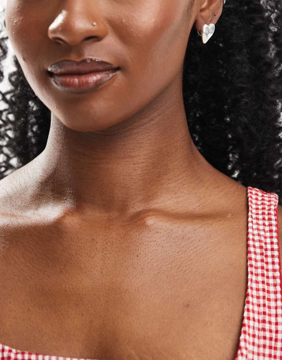 ASOS DESIGN stud earrings with molten heart detail in brushed silver