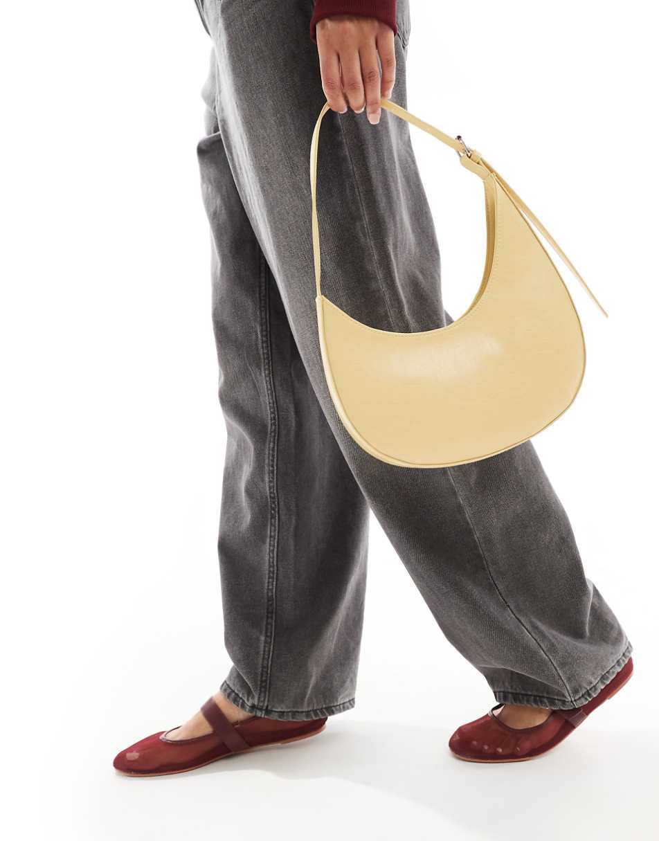 ASOS DESIGN asymmetric scoop shoulder bag with buckle detail in buttermilk