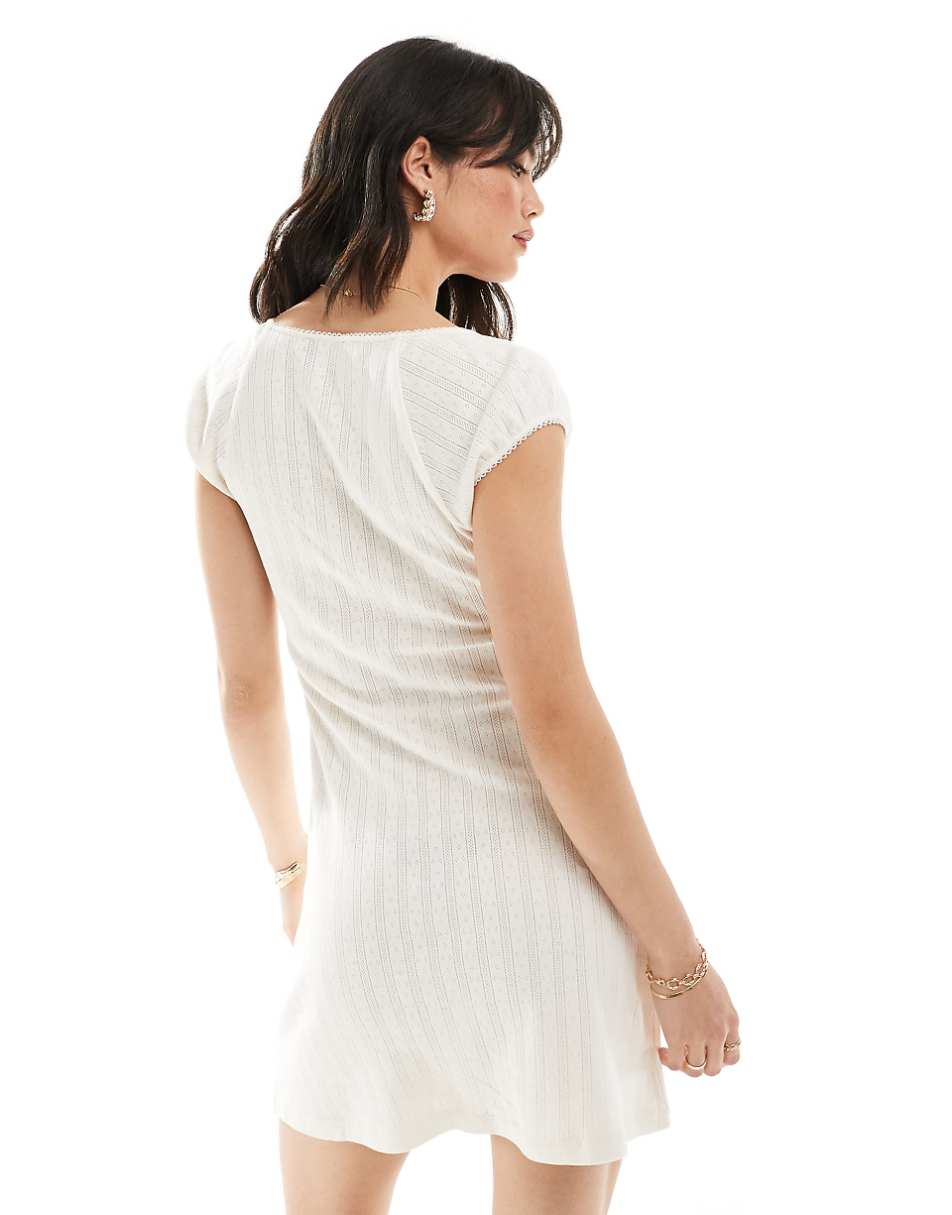 ASOS DESIGN scoop neck pointelle mini dress with bow detail in white