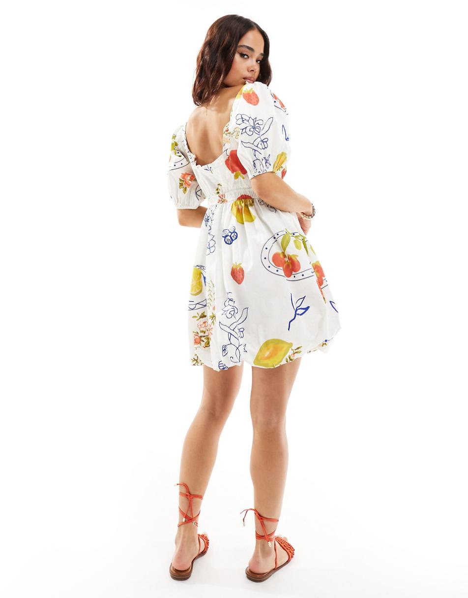 ASOS DESIGN mini puffball dress with ruffled-edge detail in fruit postcard print