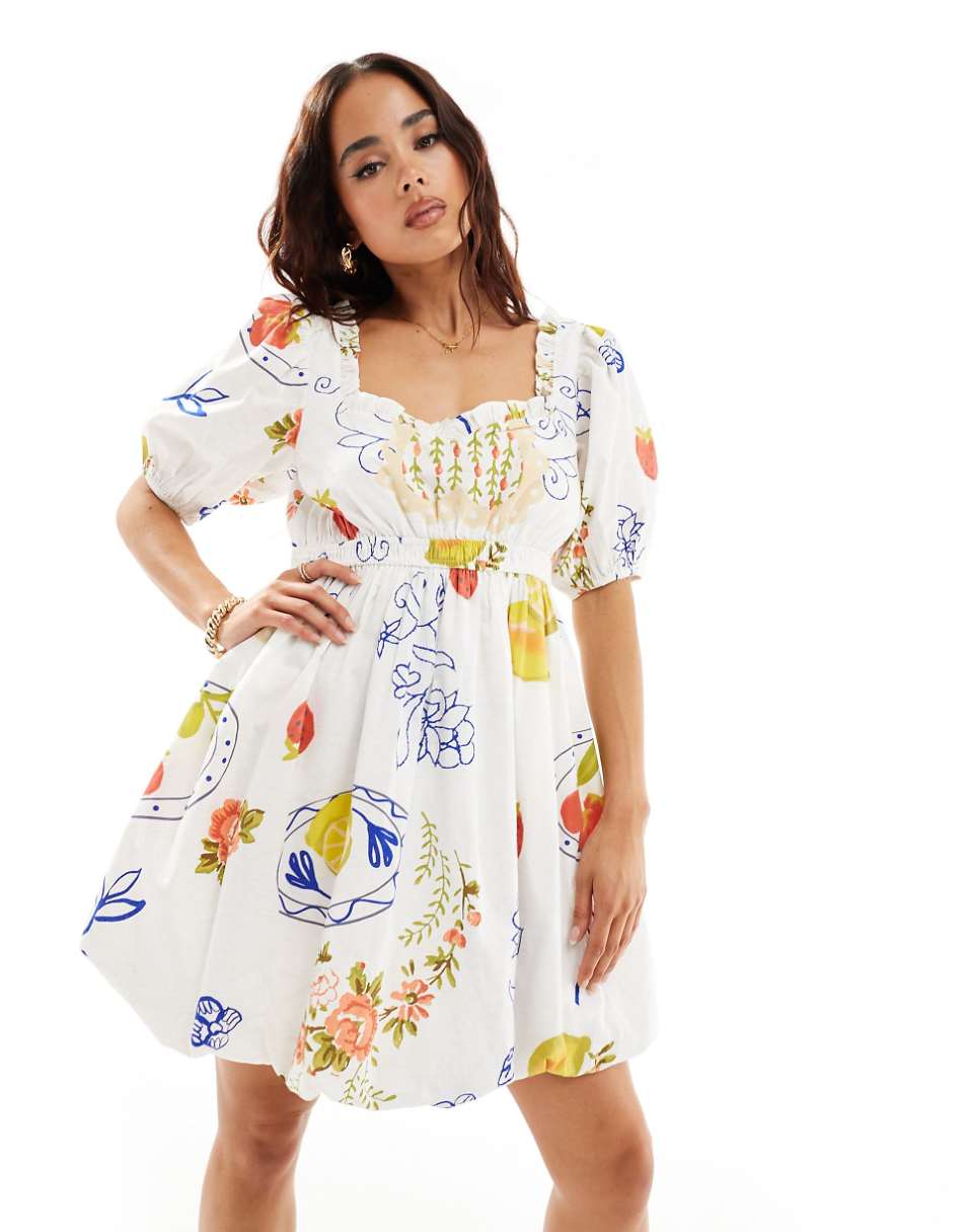 ASOS DESIGN mini puffball dress with ruffled-edge detail in fruit postcard print