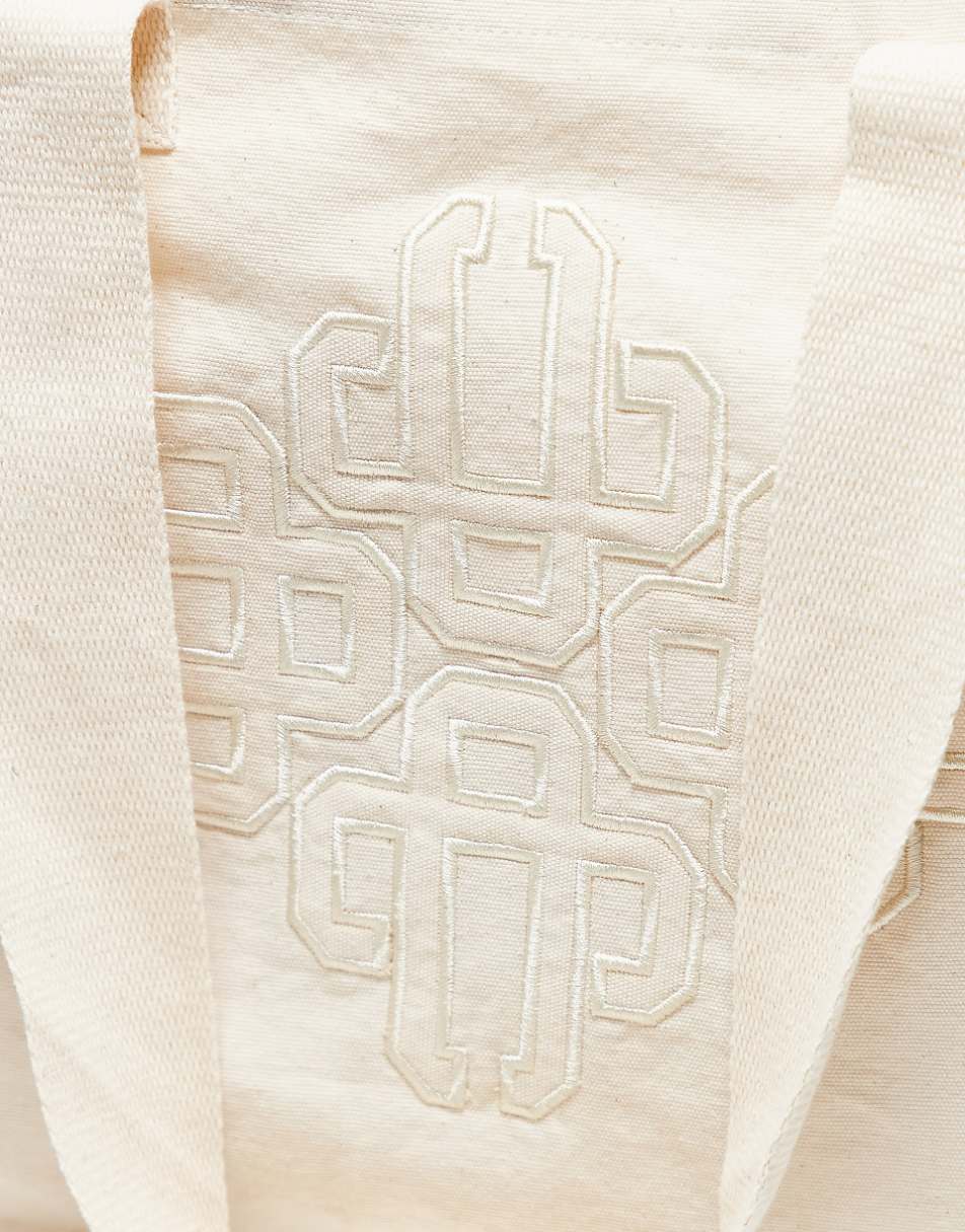 The Couture Club emblem logo tote bag in off white