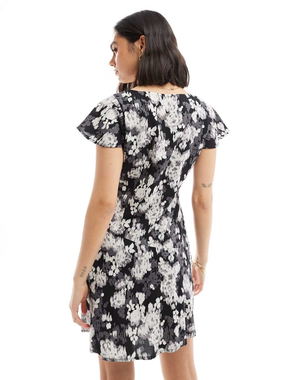 ASOS DESIGN v neck flutter sleeve mini tea dress in black and white blurred floral print