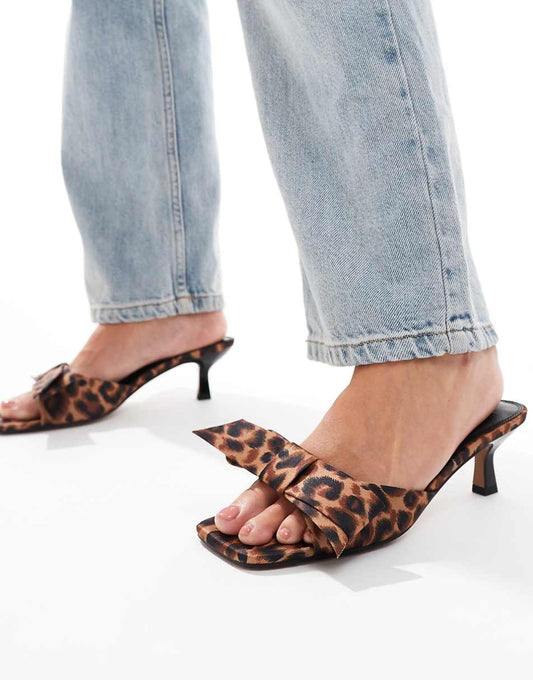 ASOS DESIGN Hyphen bow detail mid heeled mules in leopard