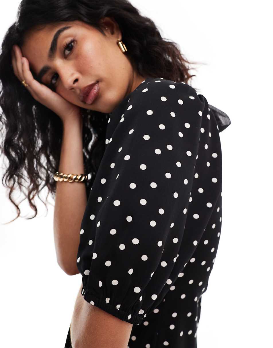 Vila mini dress with tie bow back in black and white polka dot print