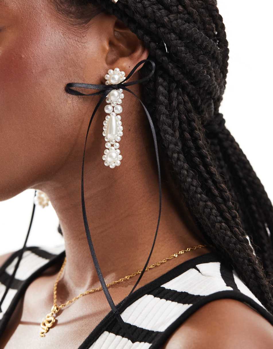 ASOS DESIGN drop earrings with faux pearl and bow detail