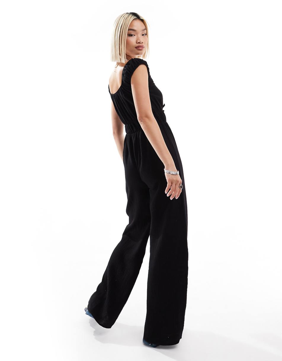 Reclaimed Vintage textured tie front jumpsuit in black