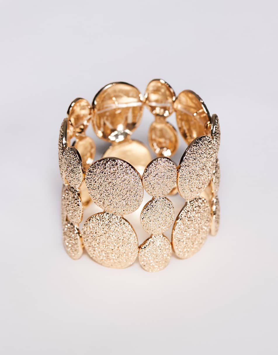 ASOS DESIGN bangle bracelet with textured pebble detail in gold tone